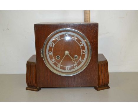 An oak cased mantel clock