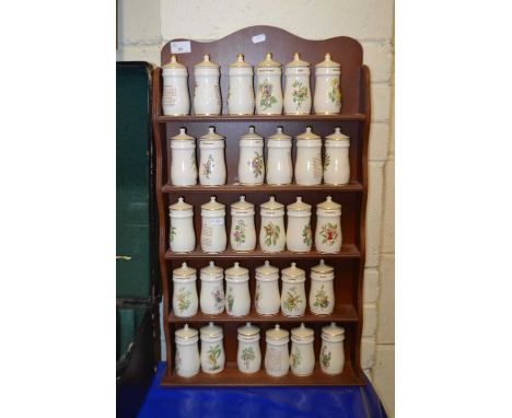 Collection of spice jars and accompanying wall rack