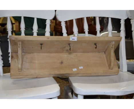 A stained pine wall shelf