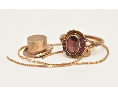 A YELLOW METAL GARNET CLUSTER RING, A TOP HAT CHARM AND A BRACELET, AF oval cluster ring, missing stones will require some at