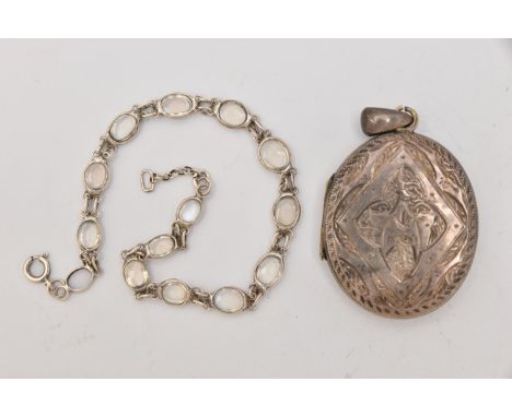 A WHITE METAL OVAL LOCKET AND A MOONSTONE LINE BRACELET, the oval locket with foliate pattern and engraved cartouche, fitted 