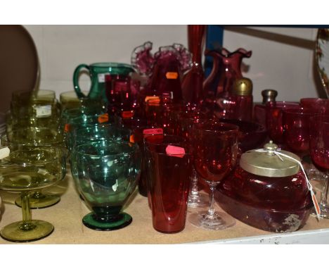 A COLLECTION OF CRANBERRY AND GREEN GLASSES eight olive green dessert dishes, four green glasses and a water jug, and a colle