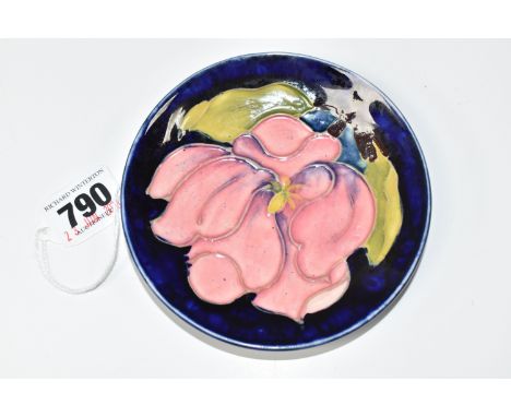 A MOORCROFT POTTERY 'MAGNOLIA' TRINKET DISH, tube-lined with a pink Magnolia flower on a blue ground, impressed 'Made in Engl
