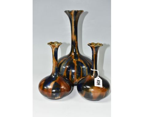 THREE NINETEENTH CENTURY BOURNE DENBY MAJOLICA VASES, onion shaped, with elongated necks and flared rim, mottled blue and bro