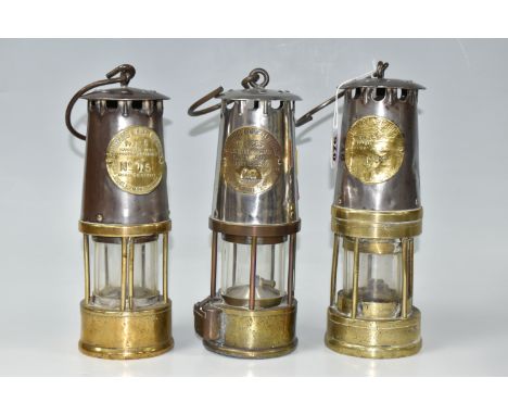 THREE MINERS' SAFETY LAMPS comprising three Protector Lamp and Lighting Co. of Eccles Manchester to include No. 15, No. 12, a