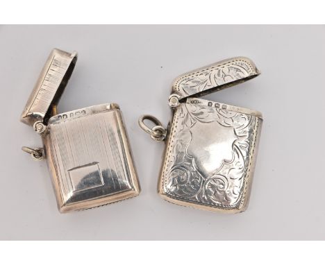 TWO SILVER VESTA CASES, both of a rectangular form, one with a foliate pattern and vacant cartouche, hinged cover, striker to