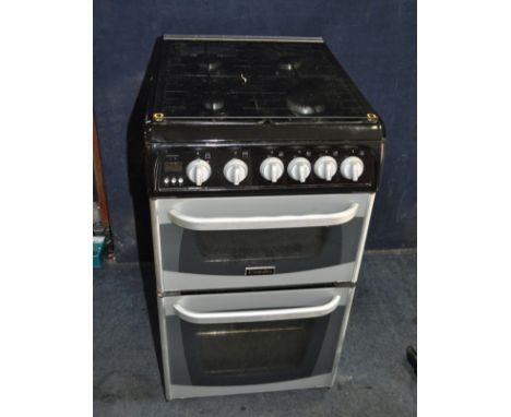 A NARROW CANNON GAS COOKER with four ring hob, glass lift up lid, oven and grill (ignition PAT pass and working)