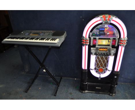 AN iTEK RETO JUKEBOX, in the form of a Wurlitzer shape, with AM/FM radio and CD player, height 123cm, and CD drawer beneath, 