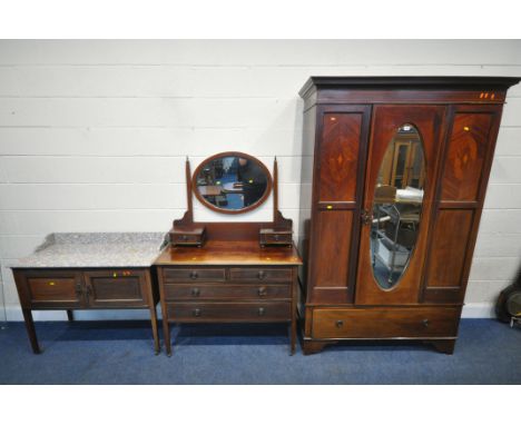 AN EARLY 20TH CENTURY MAHOGANY THREE PIECE BEDROOM SUITE, comprising a wardrobe, the single door with an oval bevelled edge m