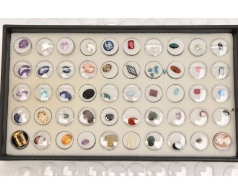 A LARGE TRAY OF CUT GEMSTONES, each in an individual capsule, stones to include amethyst, quartz, Citrine, smoky quartz, opal