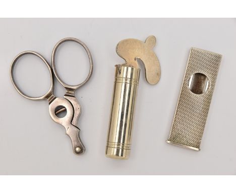 THREE SMOKING RELATED ITEMS, to include a white metal engine turned pattern cigar cutter, stamped 835, a pair of scissor form