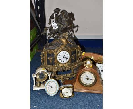 A GROUP OF VINTAGE CLOCKS, comprising a gilt eight day metal mantel clock featuring a knight on horseback, with a white porce