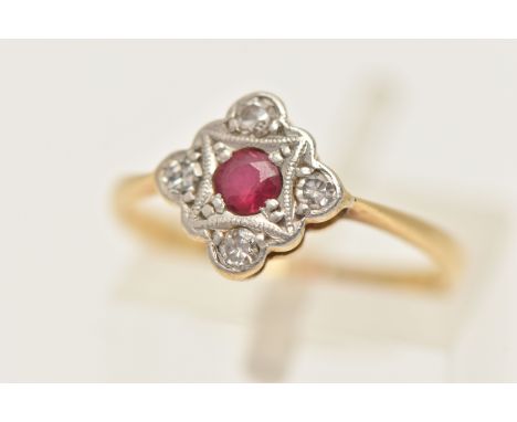 A YELLOW METAL RUBY AND DIAMOND RING, diamond shape ring head set with a central circular cut ruby, claw set in a surround of
