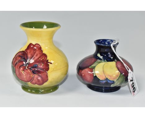 TWO MOORCROFT POTTERY VASES, in Hibiscus and Wisteria patterns, height of tallest 9.5cm (2) (Condition Report: extensive dama