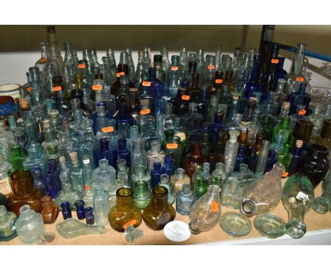 A COLLECTION OF GLASS BOTTLES, of various ages, colours and styles, many embossed, to include double ended baby feeding bottl