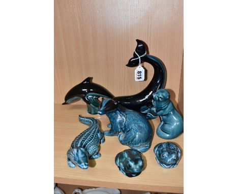 SEVEN POOLE POTTERY ANIMAL FIGURES, comprising a whale, a dolphin, a crocodile, a badger (chip on underside of base), an otte