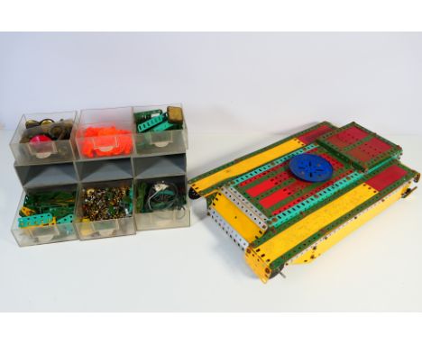Meccano - A plastic six drawer unit containing a quantity of vintage and modern Meccano parts, with a part built Meccano Tank