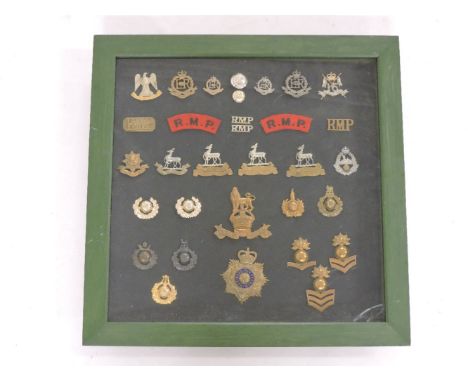 A framed collection of military cap badges, to include RMP Officer's silver (WM) cap badge, an Officer's white metal collar d