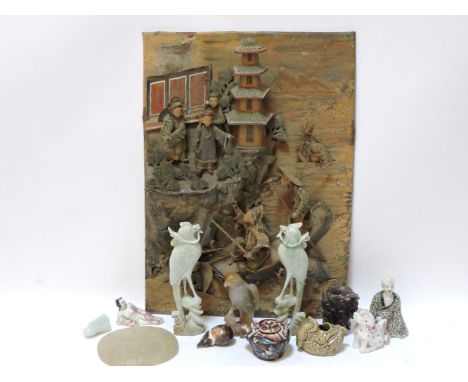 A Chinese pressed tin panel, with figures standing beside a pagoda tower overlooking the sea from which emerges sea creature 