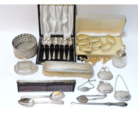 A small quantity of silver items, wine bottle coaster, decanter labels, silver backed brushes, a silver mounted scent bottle,