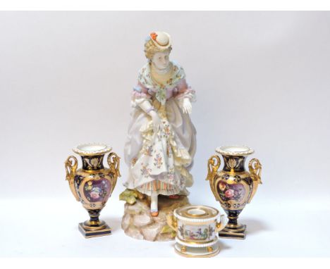 A large Continental porcelain figure of a lady, 39cm tall, a pair of Derby style porcelain urns, 17cm tall, and an inkwell, a
