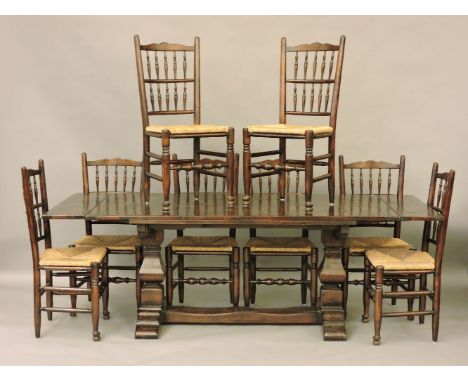 An oak draw leaf refectory table, and a set of eight matching rush seated ladder back chairs, 230cm long extended