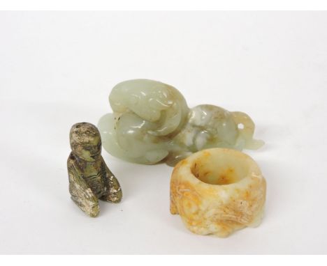 A jade ram, 7.2cm, an archer's ring carved with chilong, 3.8cm, and a kneeling figure, 3.5cm