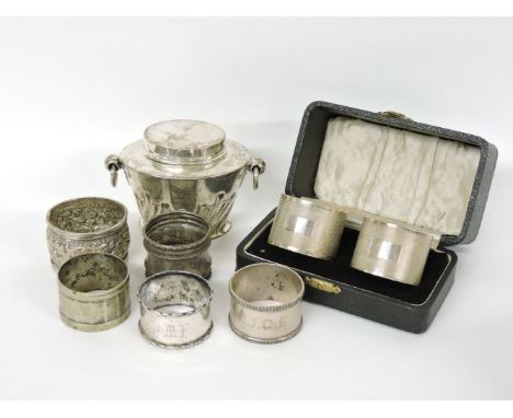 A silver tea caddy, a cased pair of napkin rings, three further silver rings, and two others