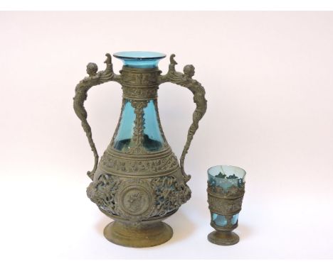 A 19th century pewter mounted blue glass decanter, with caryatid handles, 31cm high, and a mounted beaker