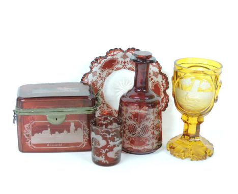 A 19th century Bohemian ruby flash casket, engraved with Bavarian scenes, a ruby flash plate, decanter, and beaker, and an am