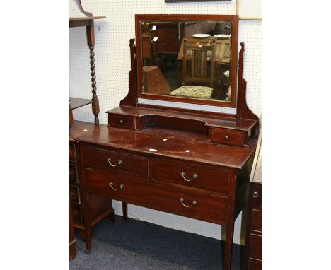 An Edwardian mahogany and strung dressing chest, the bevelled rectangular mirror over two trinket drawers, two further short 