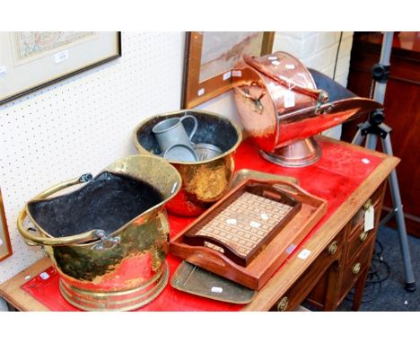 A brass helmet shape coal scuttle, a copper scuttle, small quantity of pewter tankards, a brass bell, an ejector chamberstick