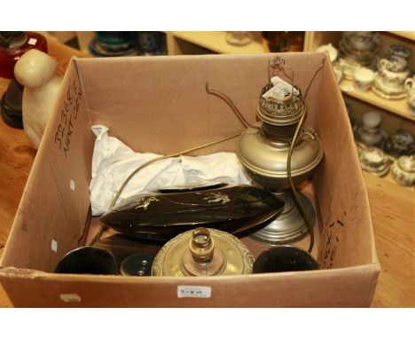 Two paraffin lamps, (one converted), a small oak barometer, a black lacquer painted bun shaped box and cover and two similar 
