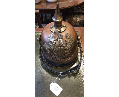 A reproduction pressed hide Prussian style pickelhaube helmet, with eagle front plate and fish scale chin strap