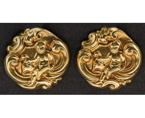 A pair of gold 19th century cufflinks, shaped circular with repousse images of cherubs amidst scrolls, figure of eight connec
