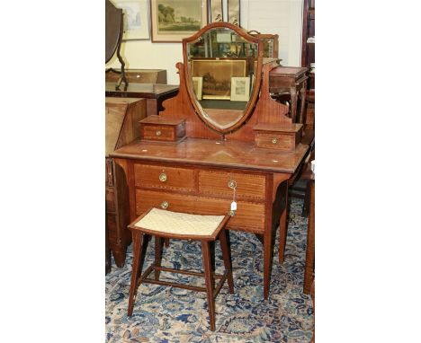 An Edwardian mahogany satinwood crossbanded and strung dressing chest, having an adjustable bevelled shield mirror flanked by