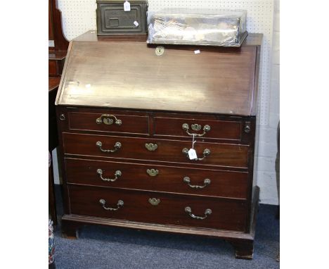 A George III mahogany bureau, the fall with moulded edge enclosing a fitted interior over two short and three graduated long 
