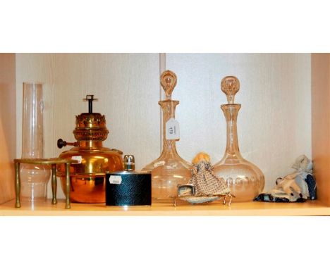 A Victorian brass paraffin lamp, two decanters, a brass trivet, hip flask, pair of EP candle snuffers, a peg doll, and two ot