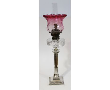 A Victorian hallmarked silver Corinthian column oil lamp with cranberry crimped glass shade and cut glass well, height (inclu