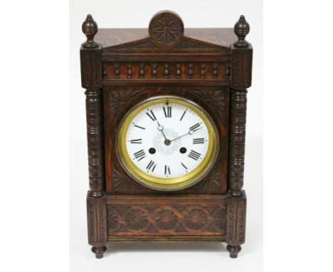 A carved oak mantel clock circa 1900, height 36cm.
