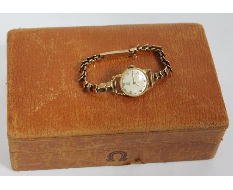 A ladie's hallmarked 9ct gold Omega wristwatch with hallmarked 9ct gold strap, gross wt. 18.6g, with box but lacking cushion.