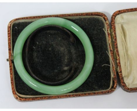 A jade coloured bangle, diam., 8cm.