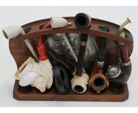A collection of vintage pipes on rack.