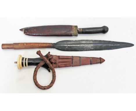 A mixed lot comprising an African knife with ebony and ivory handle and snake skin scabbard, another Eastern knife and a spea