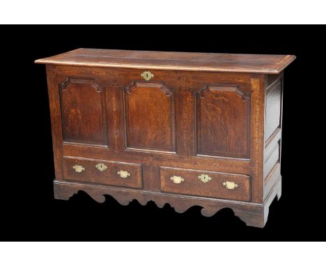 AN 18TH CENTURY MAHOGANY-BANDED OAK MULE CHEST with a three-panel front above a pair of drawers, a shaped apron below, raised