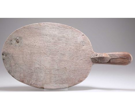 ROBERT THOMPSON OF KILBURN, A MOUSEMAN OAK CHEESE BOARD oval, with carved mouse signature to the handle. 39cm by 20.5cm