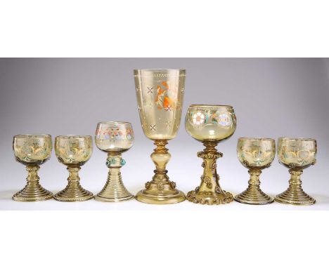 A COLLECTION OF LATE 19TH CENTURY ENAMEL PAINTED DRINKING GLASSES each decorated with prunts. (7) Largest 22.5cm high