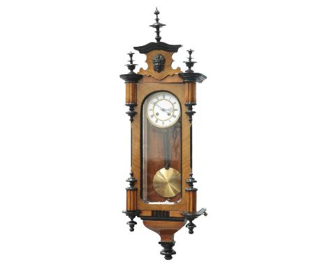 A LATE 19TH CENTURY WALNUT AND EBONISED VIENNA PATTERN WALL CLOCK with two-train movement and Roman numerals to the white ena
