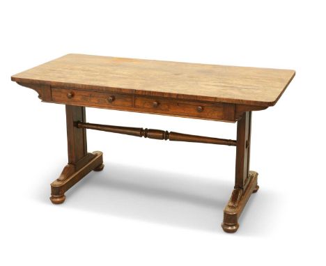 A REGENCY ROSEWOOD PILLAR-END LIBRARY TABLE the rectangular top with rounded corners, above a pair of frieze drawers, raised 