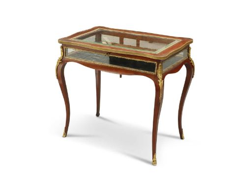 A LOUIS XV STYLE GILT-METAL MOUNTED MAHOGANY BIJOUTERIE TABLE, 19TH CENTURY the hinged cover of serpentine outline and with a